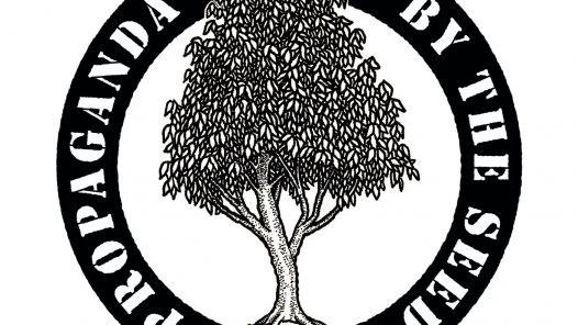 "Propaganda By The Seed" printed in loop around a tree which extends beyond the circle, circle-A in root structure,
